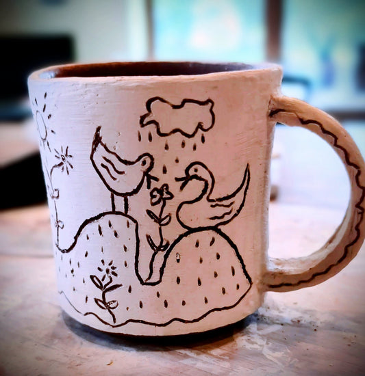 Small stoneware mug decorated with sgraffito